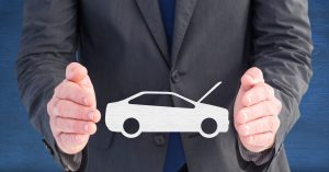 Businessman holding car safety symbol