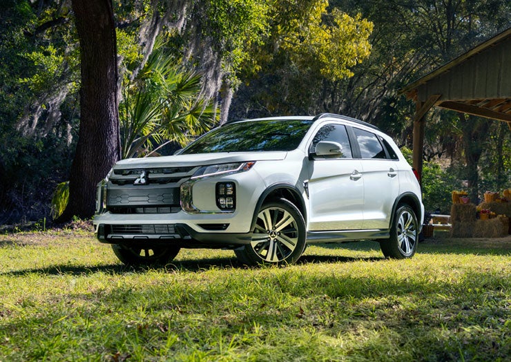 Front shot of the 2026 Outlander PHEV on a scenic road
