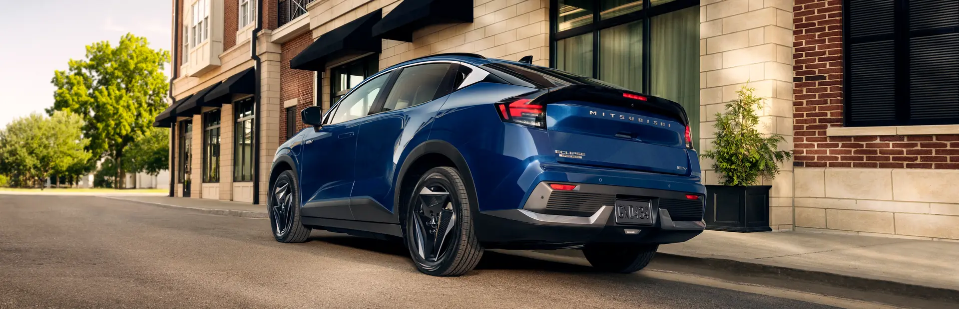 Back shot of a blue 2027 Eclipse Sportback EV parked in a city